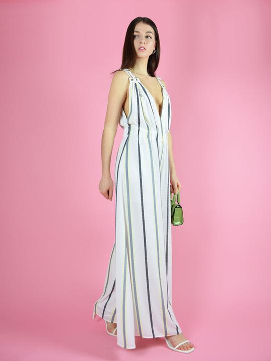 Denitsa posing in a strappy white and blue striped jumpsuit with a deep v neck