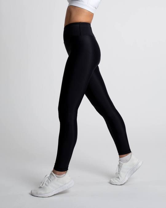 Model posing in a pair of black high rise leggings