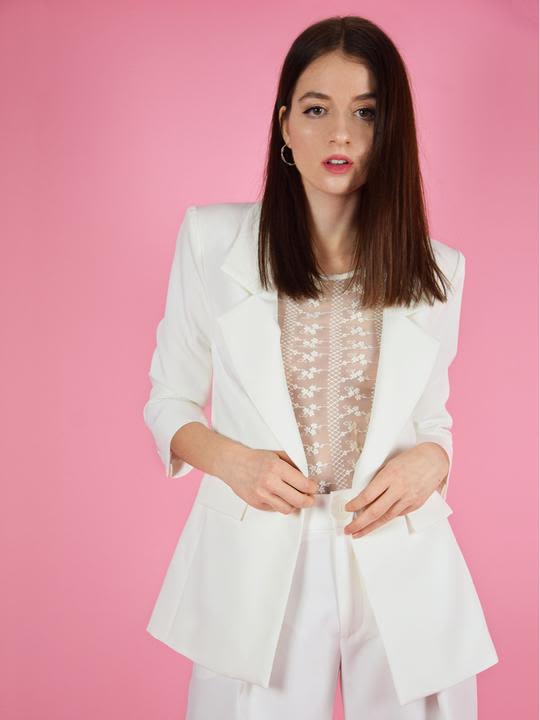 Denitsa posing in white lace top with matching white blazer